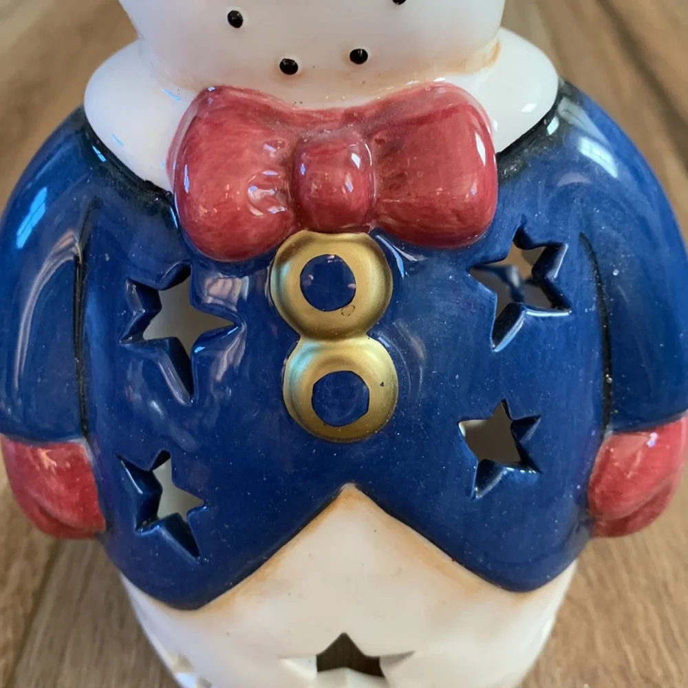 Snowman decor used as Christmas tree topper but think you can put light inside
